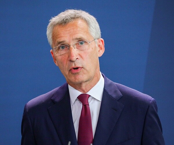jens stoltenberg speaks into microphone
