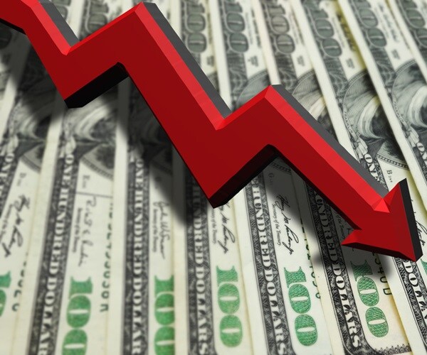 big red arrow spiraling down atop bed of dollar bills