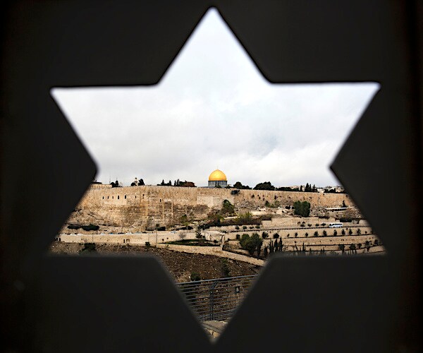 the city of jerusalem is seen through a building's window in the shape of the star of david
