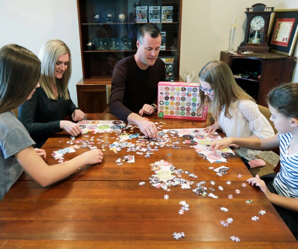 a family in seattle works on a puzzle