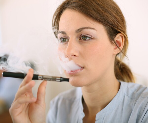woman smoking an e-cigarette