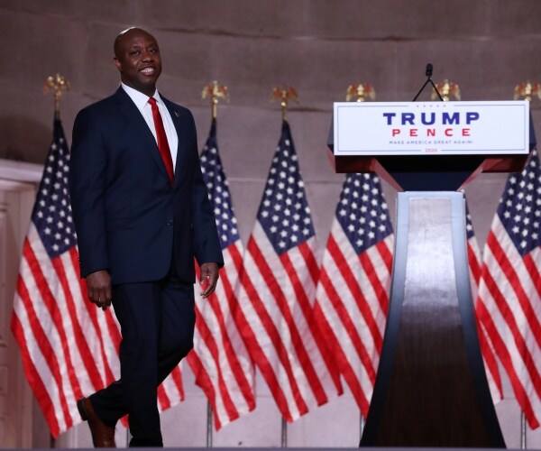 tim scott walks to podium