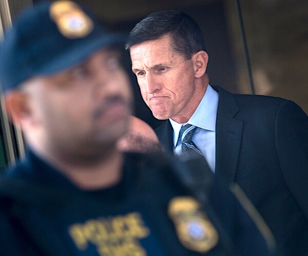 michael flynn grimaces in the background behind a police officer