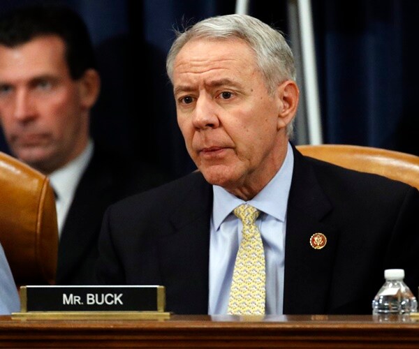 rep. ken buck of colorado sits and listens