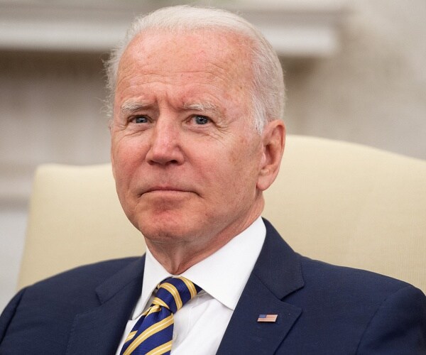joe biden sits in oval office