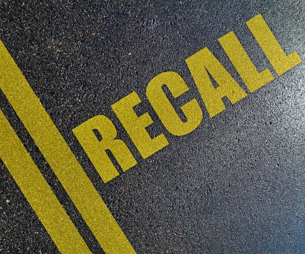 Automotive recall procedures concept on the asphalt