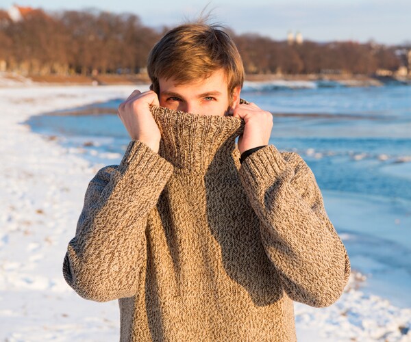a man wearing a brown sweater in cold weather