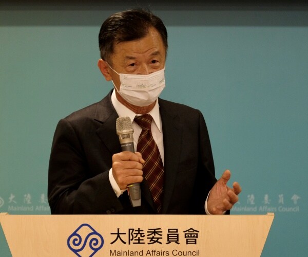 chius tai-san speaks into a microphone 