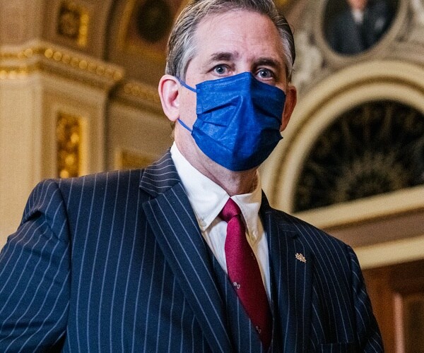 bruce castor walks through senate reception room
