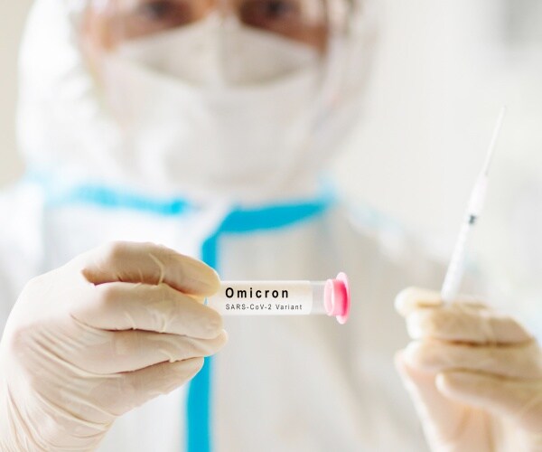 scientist with syringe and omicron variant sample