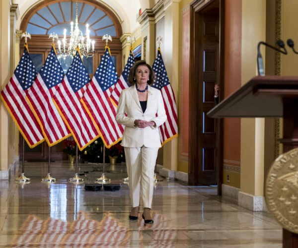 speaker of the house nancy pelosi walks to the podium to announce she is calling for articles of impeachment