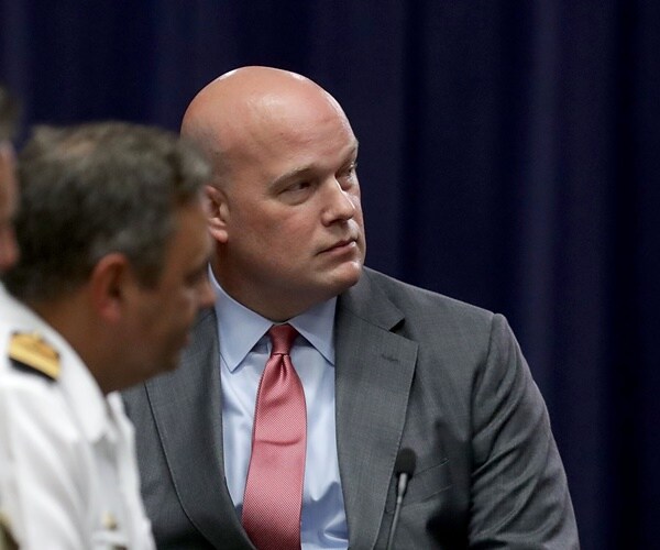 matthew whitaker listens seated