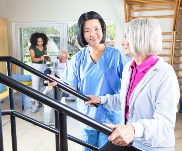 woman on exercise equipment at cardiac rehab