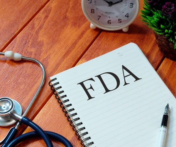 pad with 'FDA' as heading, pen, stethoscope, pills