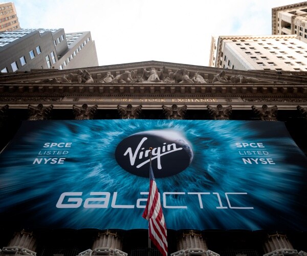 virgin galactic logo outside nyse with a us flag