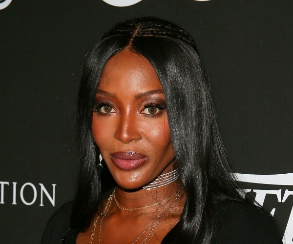 naomi campbell stands on red carpet