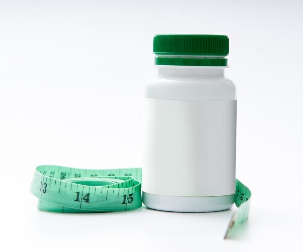 measuring tape, generic bottle of pills