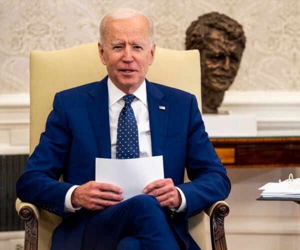 U.S. President Joe Biden sitting on a chair.