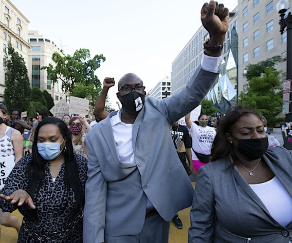 philonise floyd walks with left fist raised up in protest