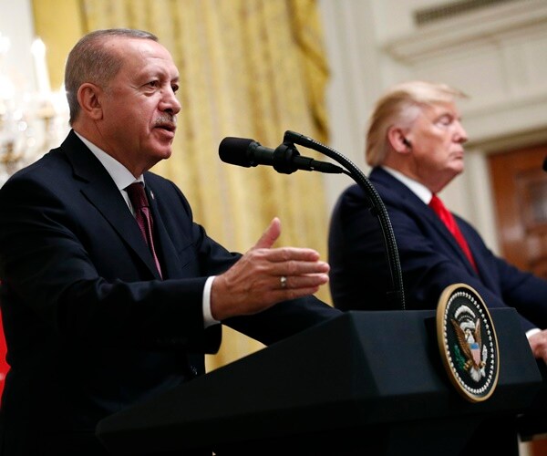 president erdogan and president trump both stand at podiums at a news conference