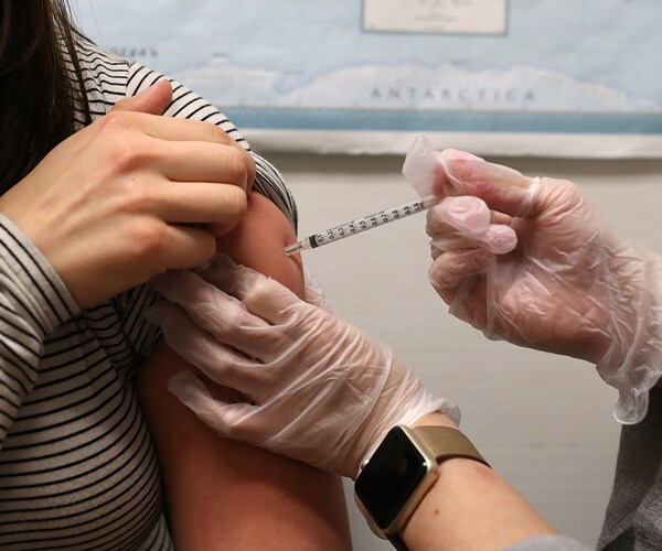woman receives flu shot