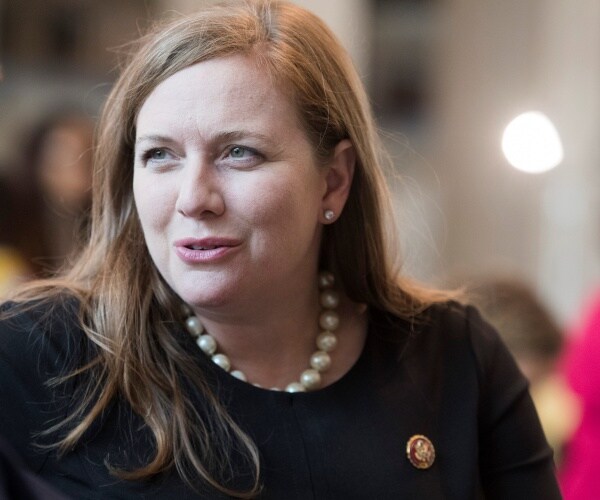 lizzie fletcher sits on bench