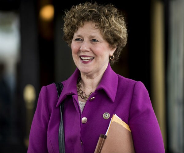 rep. susan brooks leaves capitol hill wearing a purple suit with gold buttons
