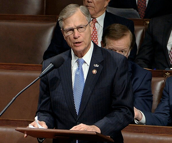 rep brian babin stands in the front of the house and speaks to his colleagues