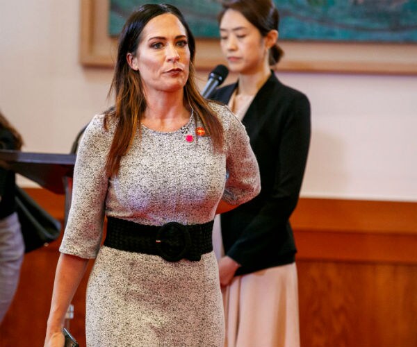 White House Press Secretary Stephanie Grisham is shown in a black and white dress at The White House.