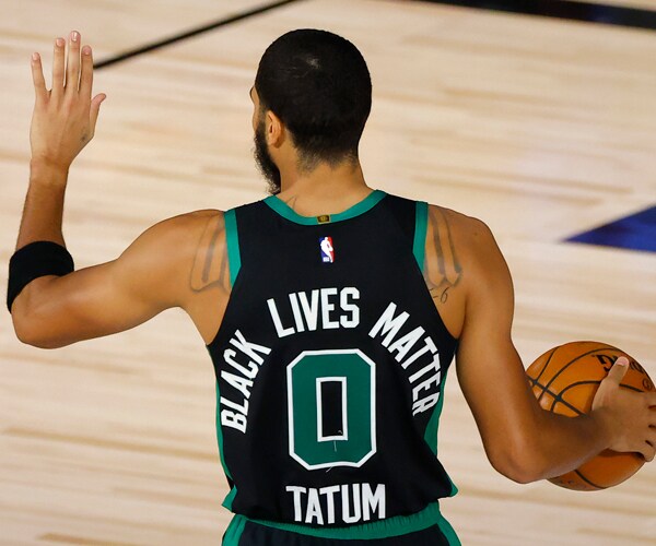 basketball player jayson tatums jersey reads black livers matter on the back