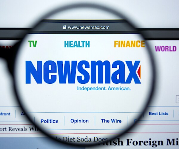 the newsmax logo under a magnifying glass
