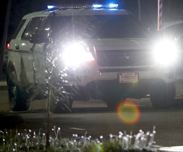 a police car has its lights flashing and headlights bright in the dark of the night