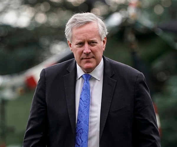 mark meadows walks across the lawn at the white house