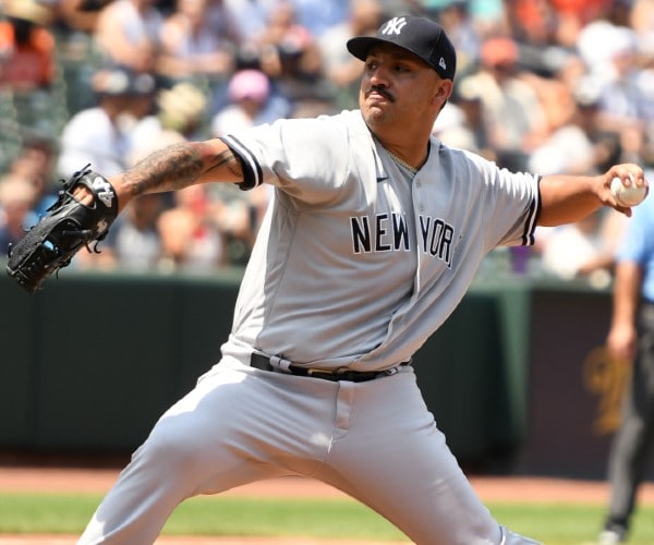 cortez pitching a baseball in a yankees uniform