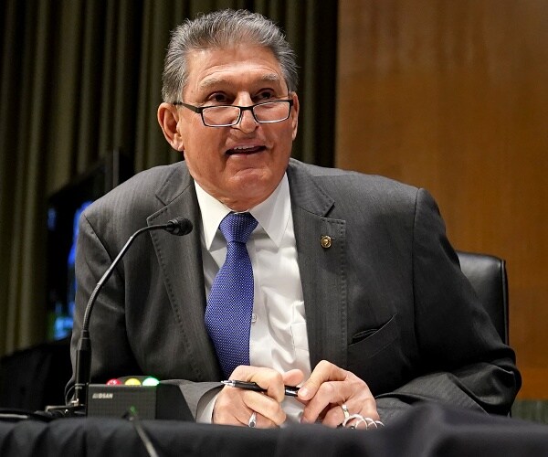 joe manchin speaks into microphone