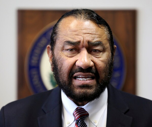 al green stands with a pensive expression