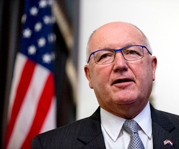 Pete Hoekstra speaks with an american flag behind him over his right shoulder