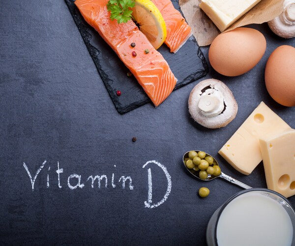 a black slate board with salmon, eggs, and cheese