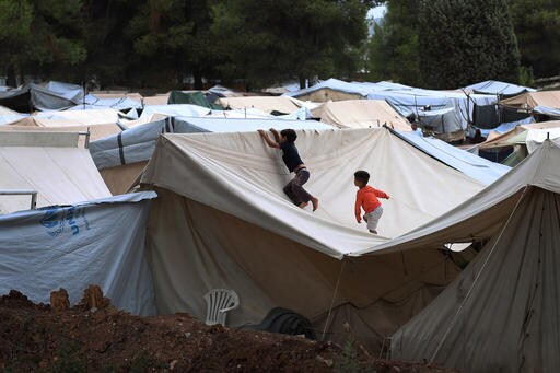 The Latest: Romania Police Find 10 Migrants Hidden in Truck