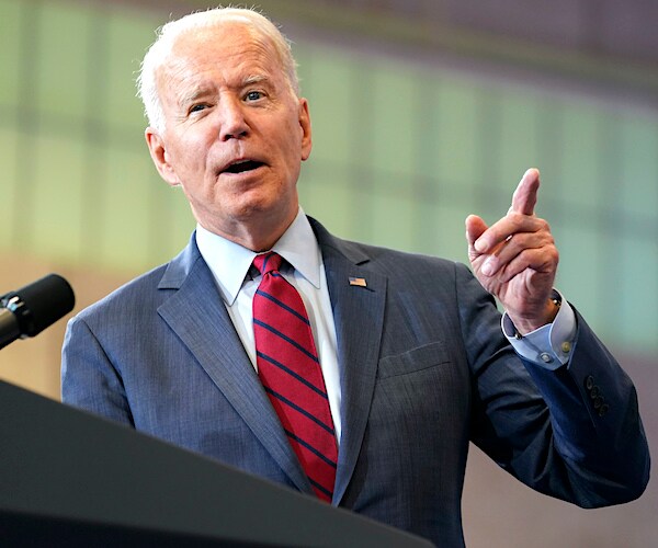 president joe biden points and speaks during a news conference